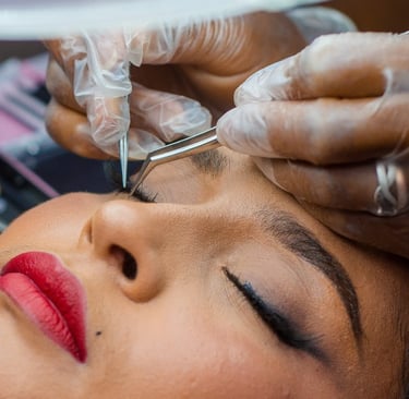 a woman getting her eyebrows done by a professional hairdresser