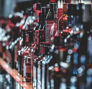 a bunch of bottles of alcohol on a bar