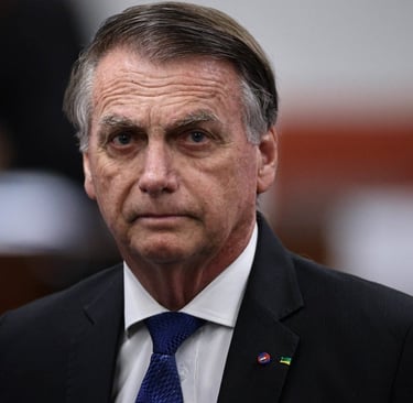 Close de Jair Bolsonaro, com uma expressão séria, olhando para a câmera.