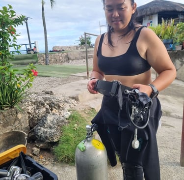 Sugbudiver setting up her dive gear for scuba diving