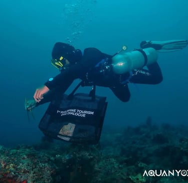 Scuba diver Chu Taga Isla outdoors picking up trash with tourism bag