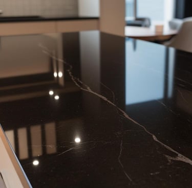 a kitchen counter top with a black granite counter top