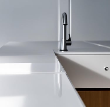 a corian kitchen counter top with a sink and a faucet faucet fa