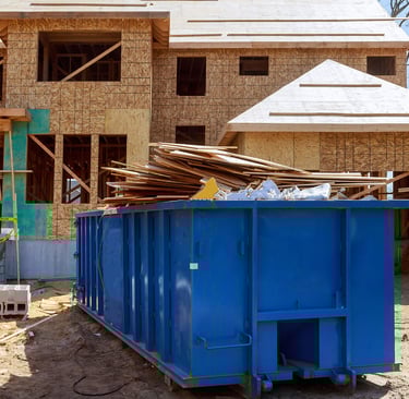 construction debris piled in dumpster 