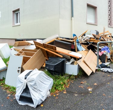 broken furniture piled along driveway