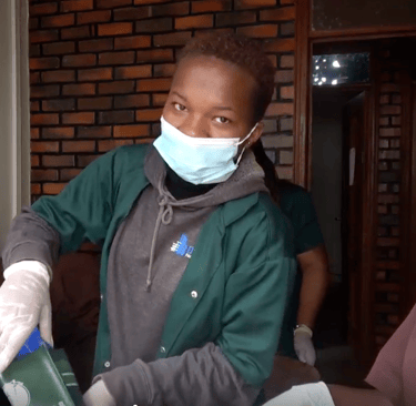 a group of people wearing masks and gloves preparing coffee
