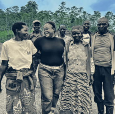 a group offarmers standing on a coffee farm, nlack and white photo