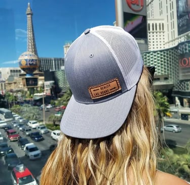 a woman wearing a hat and a leather patch