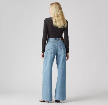 Back view of Levi’s XL Straight Jeans in light wash denim, styled with black top and heels.