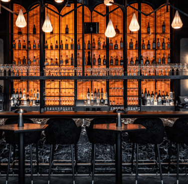 Lucky Cat BishopsGate,Luxury cocktail bar with ambient lighting, premium spirits, and elegant decor.