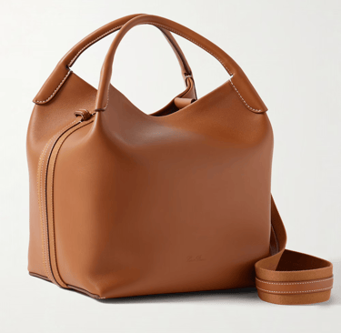 Luxury tan leather handbag with a structured silhouette and contrast stitching.