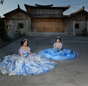 two women in quince dresses sitting on the ground
