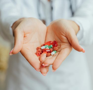 a woman holding a bunch of pills and pills
