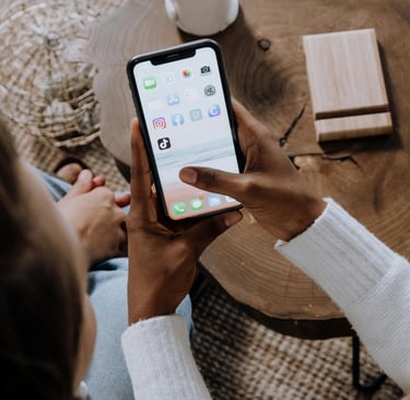 Someone Browsing a mobile phone optimizing campaigns