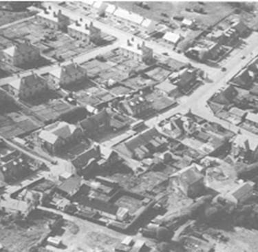 a black and white photo of a city street scene