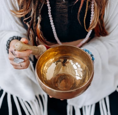 A woman playing a singing bowl. It's Reiki time.