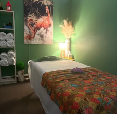 Tranquil Thai-style massage room at Ashburton Thai Massage & Spa with soft lighting, comfortable massage bed, and traditional