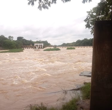 a river with a bridge and a bridge in the background