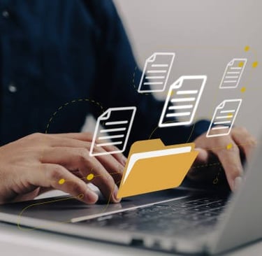 Person typing on a laptop with digital folder icons and document files for online data management.