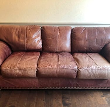 vintage brown leather sofa with pined trim