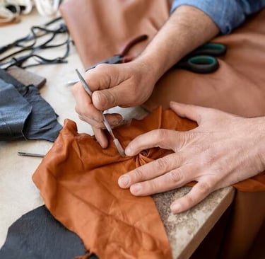 technician repairing orange leather material 