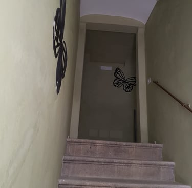 a stairway way with a butterfly on the wall