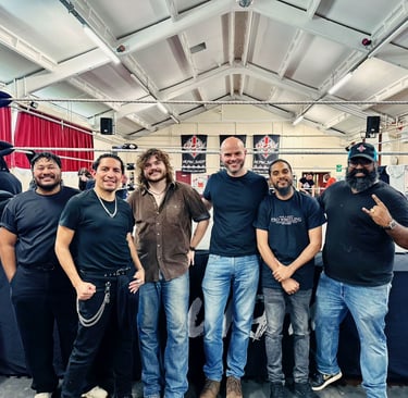 a group of students stand infront of a wrestling ring