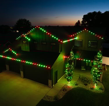 Red & Green Seasonal Lighting On Home and Trees