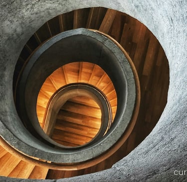 a spiral staircase way with a wooden spiral staircase