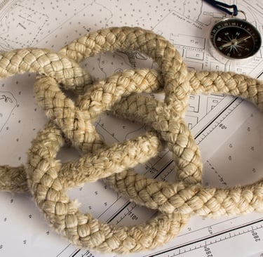 a nautical knot on a chart with a compass