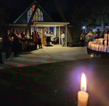 A prayer vigil for the unhoused who died. There is a candle for each death.