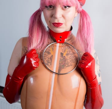 a woman in latex costume with a red leather collar