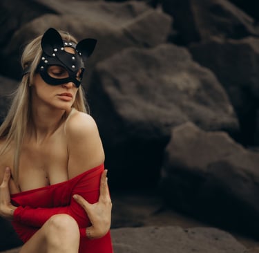 a woman in a red dress and black cat mask