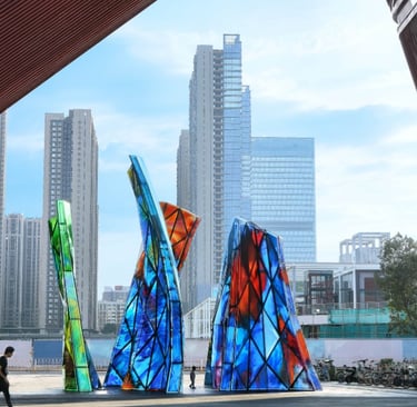 Blooming Sculpture by Shan Shan Sheng in the daytime with the city skyline behind it