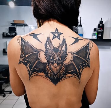 a woman with a bat - like tattoo on her back