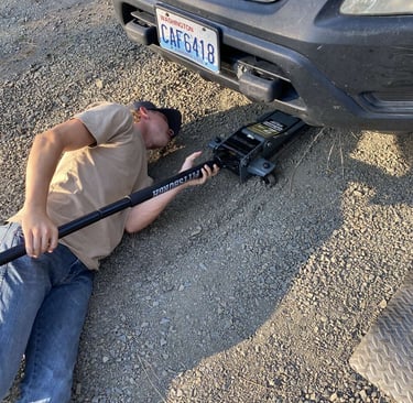 Elias jacking up a car