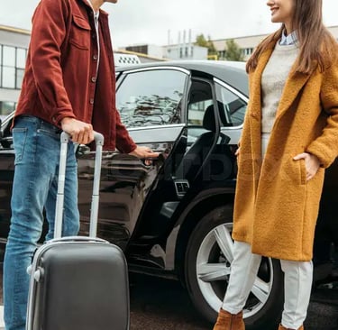 A friendly taxi driver assisting a passenger with luggage