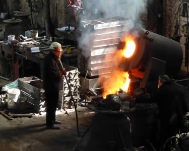 Pouring moulten bell metal