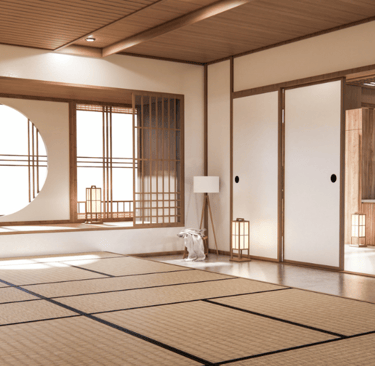 Tatami mats covering the floor of a Japanese-style room with sliding doors and paper lanterns.