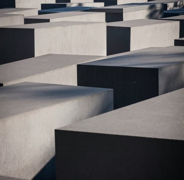 Array of varied concrete blocks with strong shadows.