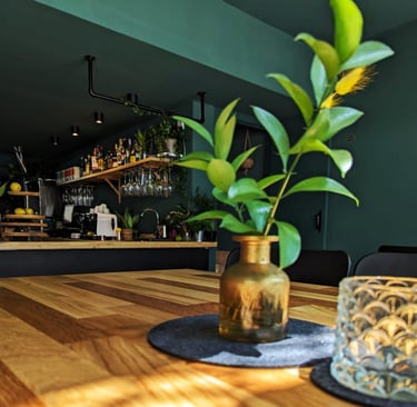 a vase with a plant in it sitting on a table