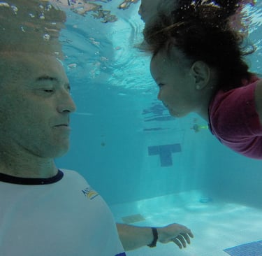 a man and a woman swimming in a pool