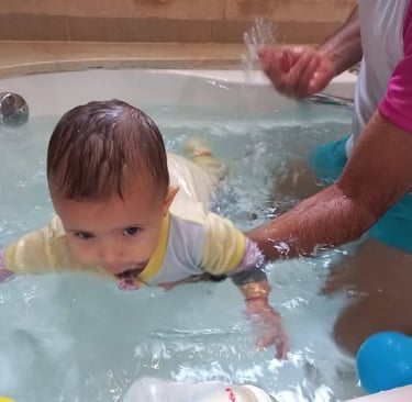 a baby in a tub with a man in a bathtub