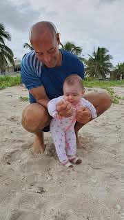 a man holding a baby in his arms