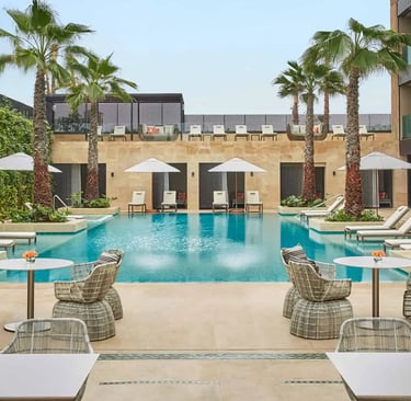 Oceanfront pool area at Four Seasons Hotel Casablanca with luxury seating, palm trees