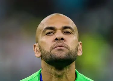 dani alves with a green jersey and a blue shirt