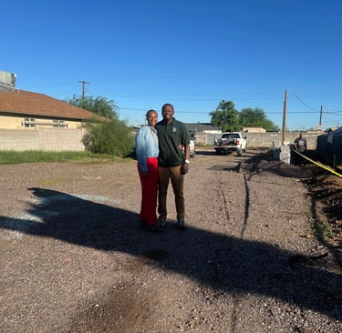 Fred and Tommyka stand next to each other at the development site