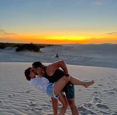 a man and woman are kissing on the beach