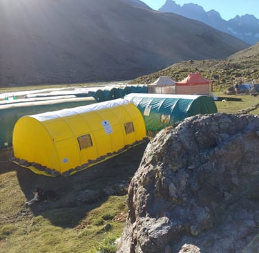 a group of tents with tents and tents in the background