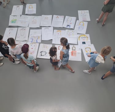 a group of people standing around a large group of drawings